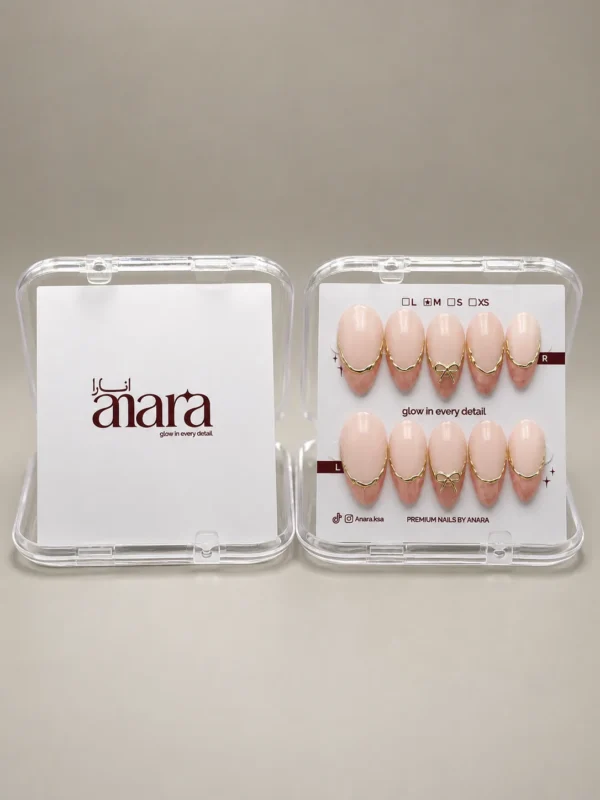 Nude Gold French Bow press-on nails, medium almond: up close