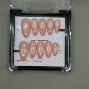 Peach Bow Press-On Nails — Long Almond, Cat-Eye and Charm — twenty-four nails in the ANARA box